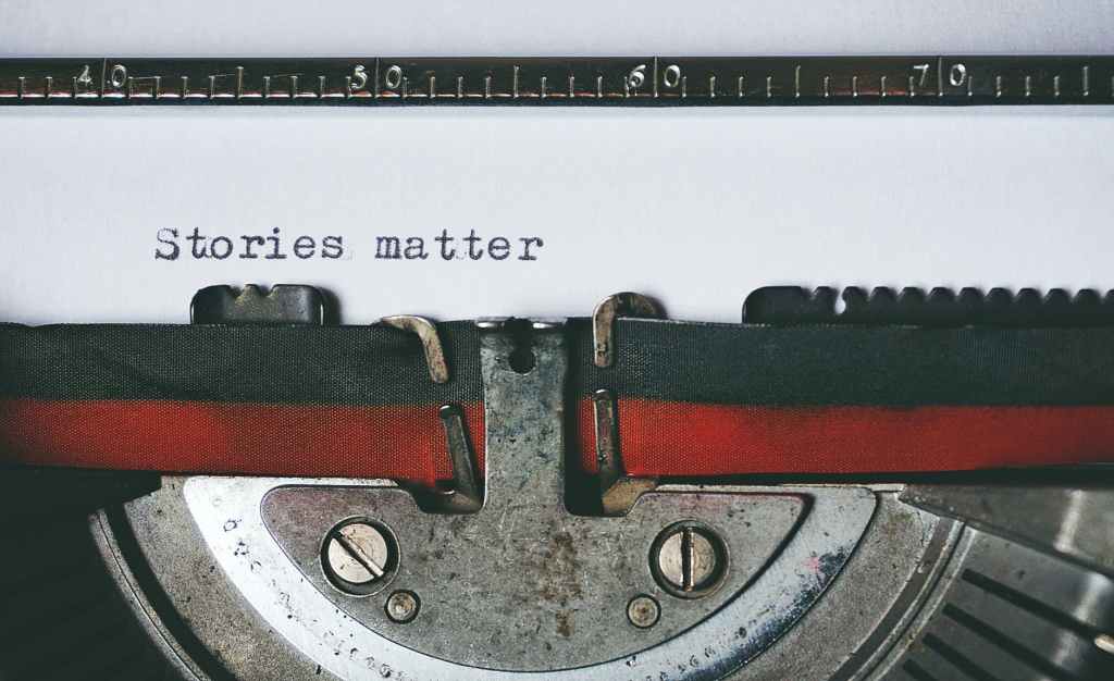 Picture of a typewriter with the words "stories matter" on the paper.